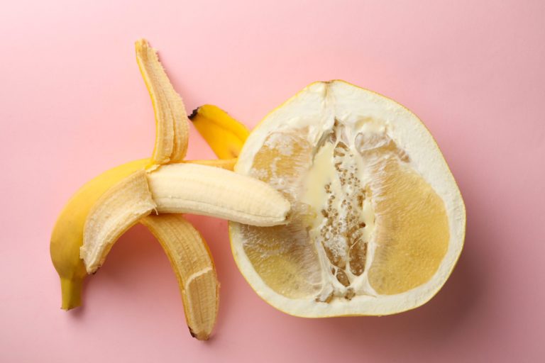 Banana and pomelo fruit with condensed milk on pink background