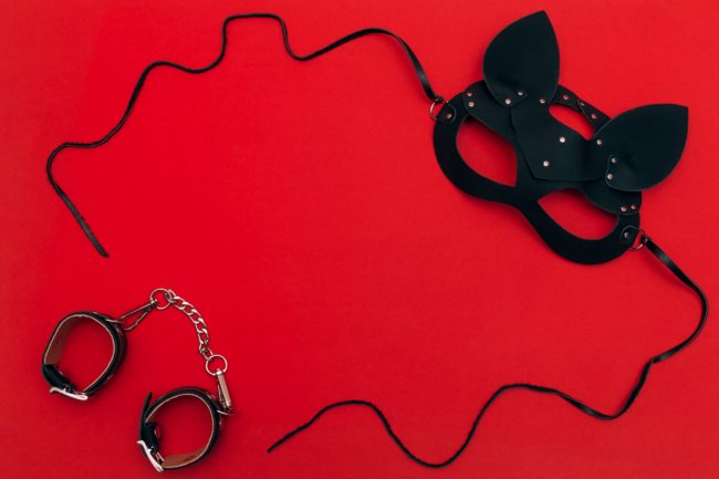 black-leather-cat-mask-on-a-red-background-concept-2021-09-01-13-45-59-utc
