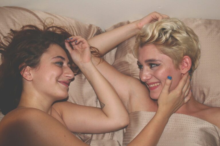 two girls in bed ready to have kinky sex for national kink month