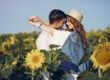 Beautiful and stylish couple in a summer field with sunflowers