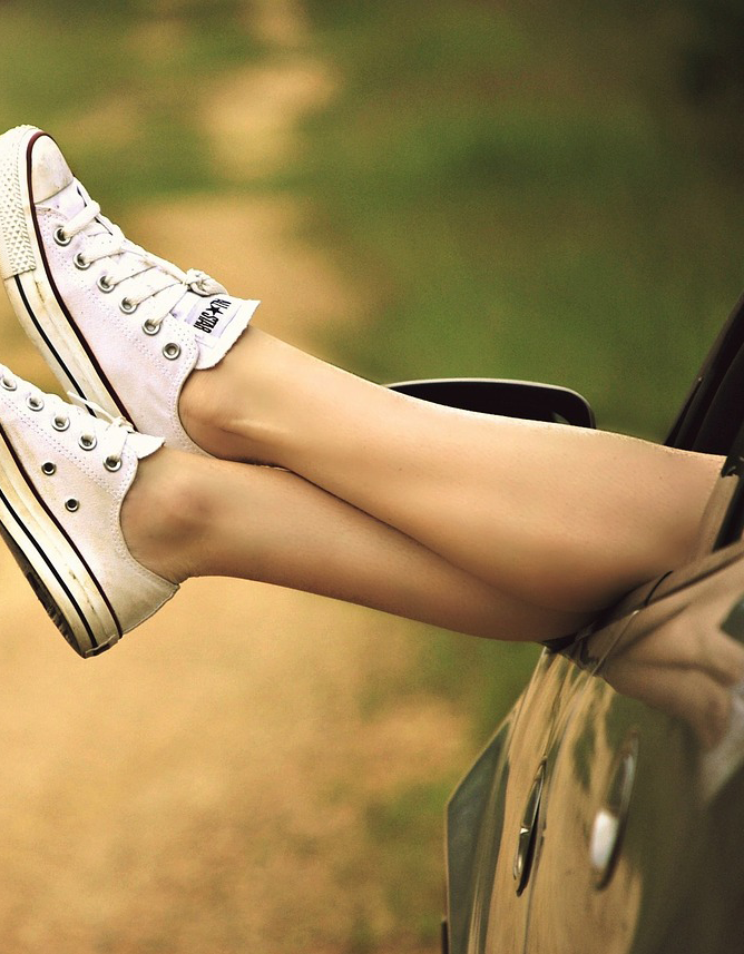 Ladies feet dangling out car window