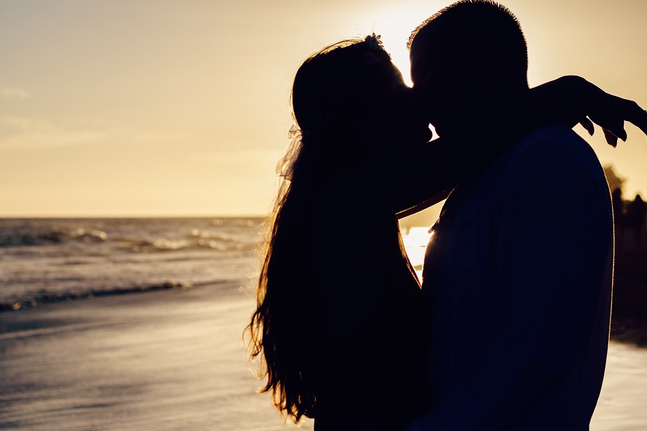 couple kissing on beach