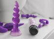 Various sex toys sitting on side table next to bed